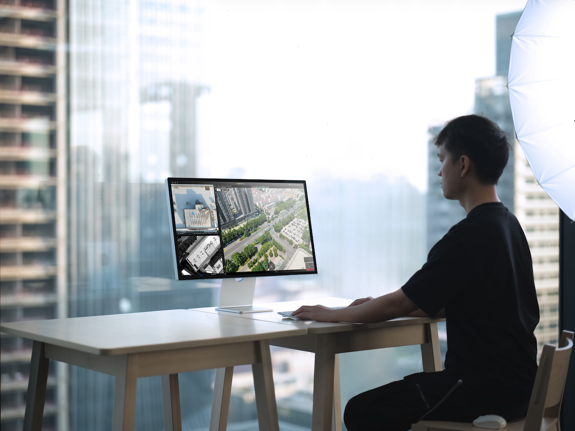 A BVLOS operator at a desk monitoring live footage shared instantly via the O4 Ground Station. | Image Credit: DJI