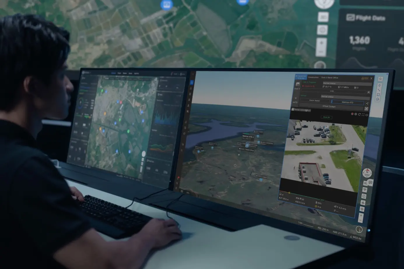 A man sits in a control room overseeing the BVLOS operations of the DJI Dock